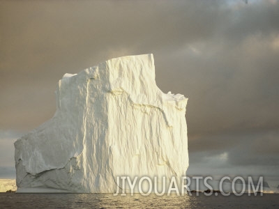 twilight view of a large iceberg under a cloudy sky