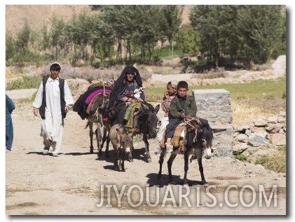 Aimaq People Walking and Riding Donkeys Entering Village, Between Chakhcharan and Jam, Afghanistan