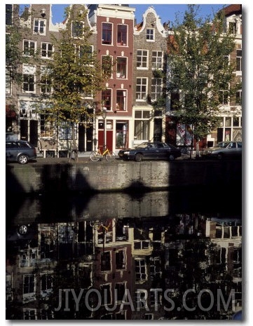 Tall Traditional Style Houses Reflected in the Water of a Canal, Amsterdam, the Netherlands