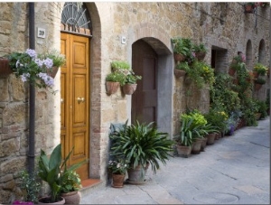Flower Pots and Potted Plants Decorate a Narrow Street in Tuscan Village, Pienza, Italy