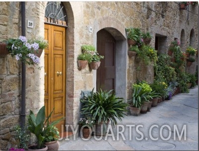 Flower Pots and Potted Plants Decorate a Narrow Street in Tuscan Village, Pienza, Italy