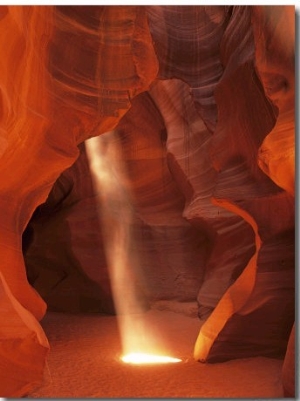 Sunbeam Illuminates Sandy Floor and Sandstone Walls of a Slot Canyon