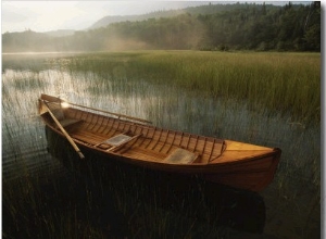 An Adirondack Guide Canoe Floating on Connery Pond at Sunrise