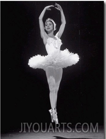 Ballerina Margot Fonteyn in White Costume Leaping into the Air While Dancing Alone on Stage