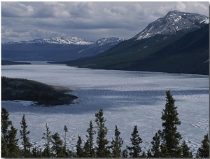 Snow Capped Moutains Rise Above a Frozen Waterway on Kodiak Island