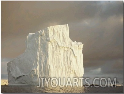 Twilight View of a Large Iceberg Under a Cloudy Sky