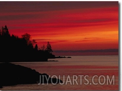 A Bright Red Sky over Lake Superior at Dawn with Silhouettes of the Rocky Coast