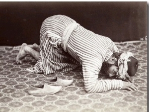 A Man, Kneeling Down, is Rapt in Prayer