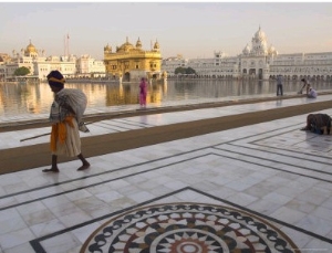 Elderly Sikh Pilgrim with Bundle and Stick Walking Around Holy Pool, Amritsar, India