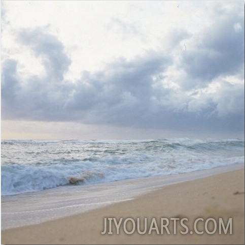 Clouds Above Ocean Waves and Beach