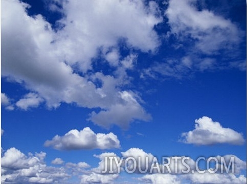 Sunlit Fluffy White Clouds in a Blue Sky