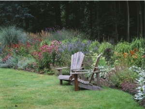Sweeping Border Beside Wooden Adirondack Chairs with Echinacea, Nepeta and Grasses