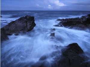 High Tide Brings in Waves on a Rocky Shoreline