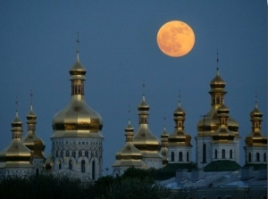 A Full Moon Rises in the Night Sky During a Lunar Eclipse