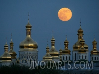 A Full Moon Rises in the Night Sky During a Lunar Eclipse