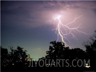 Bolt of Lightning Brightens a Night Sky