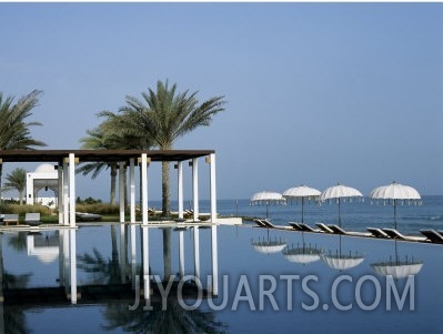 Reflections in the Still Water of the Infinity Pool at the Chedi Hotel