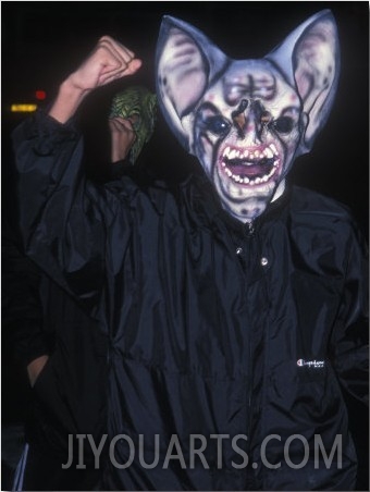 French Halloween Reveler in a Mask with Teeth and Big Ears