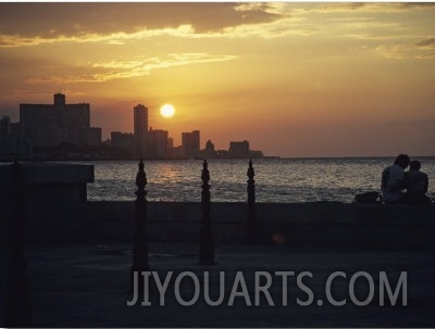 A Couple Embraces on Havanas Malecon