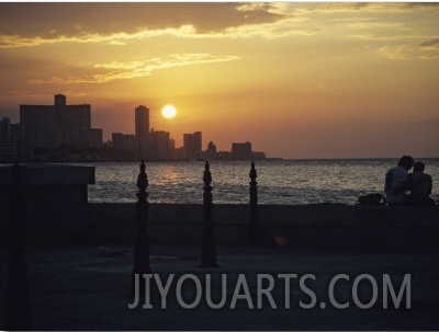 A Couple Embraces on Havanas Malecon