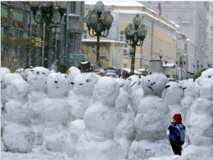 A Child Plays Among the Snowmen Made at the Arbat