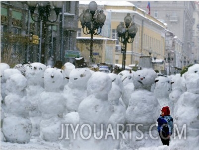 A Child Plays Among the Snowmen Made at the Arbat
