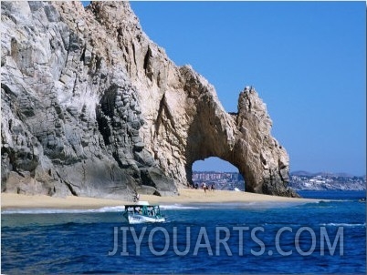 Tour Boat in the Water by El Arco, a Natural Arch at Land