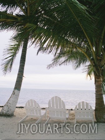 White Beach Chairs Line the Shore of the Caribbean Sea in Belize
