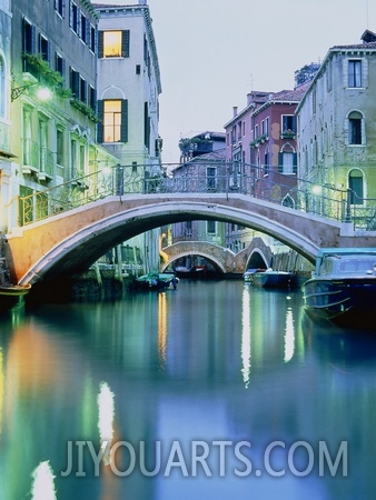 Bridge above a channel in Venice  evening shot