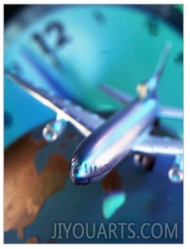 Model Jet Over Glass Globe with Clock Behind